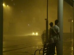 Couple watch extreme hurricane winds and rain, Typhoon Koppu, Hong Kong on night of 14th sept 2009. With Audio. Stock Footage
