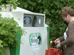 MS woman throwing bottles in bottle bank / Saarburg, Rhineland-Palatinate, Germany Stock Footage