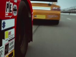 LA TS CU Racecar wheel driving on racetrack behind another car / Long Pond, Pennsylvania, USA Stock Footage