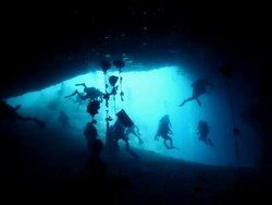 MS Shot of Silhouette of divers at entrance of Turtle Tomb cave in Sipadan / Sipadan, Semporna, Tawau, Malaysia Stock Footage