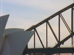 WA people scaling walkway on top of Sydney Harbour Bridge, edge of Sydney Opera House overlapping Bridge at edge, Sydney, Australia Stock Footage