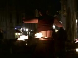 MS TS Female fire dancer dancing with flaming hula hoop on street at night / Dresden, Saxony, Germany Stock Footage