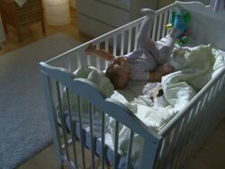 HD CRANE: Sleepless Baby Moving In A Crib Stock Footage