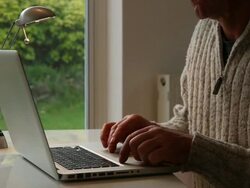 Using laptop. Man at desk, close. Stock Footage