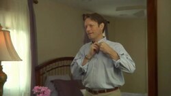 MS, Man buttoning shirt in front or mirror, Edison, New Jersey, USA Stock Footage