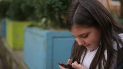 Little girl with smart phone Stock Footage