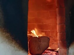 burning wood in a tandoor Stock Footage