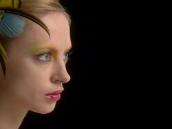 Face of young woman with feather accessory in hair Stock Footage