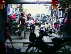 MS SLO MO Shot of closing of small store at night and woman sweeping floor / Luang Prabang, Laos Stock Footage