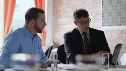 Financial advisor explains bar graph results to restaurant owner in business meeting Stock Footage