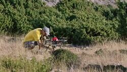 Pilot checking drone before flight on sunny hilltop Stock Footage