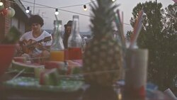 Playing guitar with friend on rooftop party Stock Footage