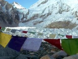 Mount Everest with Buddhist prayer flags in the foreground. Stock Footage