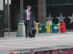 MS Well dressed young man walking with suitcase in downtown urban area / Minneapolis, Minnesota, United States Stock Footage