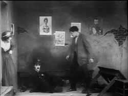 B/W 1917 policeman Charlie Chaplin falling into room + getting punched by junkie / woman in room too Stock Footage