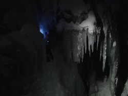  MS PAN Looking across on ice climber in night and Climber breaks ice to scale up  climb using hooks  / Ouray,CO,USA Stock Footage