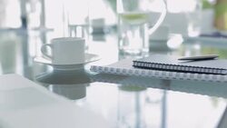 Close up of notebooks, coffee cup and laptop Stock Footage