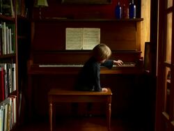 Slow push in on boy playing the scale on the piano. Stock Footage