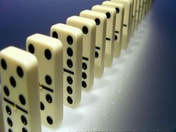 High Speed Dominoes - MCU side angled view, row of dominoes fall over away from camera Stock Footage