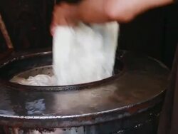 CU Short of man putting woven rug into vat to add color to it / marrakech, tensift, morocco Stock Footage