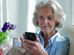Senior texting sofa    CM LI RO Stock Footage