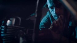 Man in motorcycle workshop building a bike Stock Footage