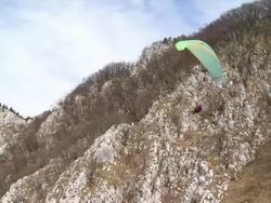 HD: Paraglider Flying Over The Mountain Range Stock Footage