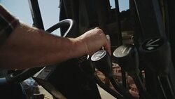 Masculine hands operate the steering wheel and controls of a forklift. Stock Footage