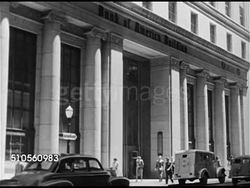 1948: SAN FRANCISCO, CALIFORNIA: FINANCIAL DISTRICT: LS Montgomery Street. Angled WS Exterior Bank of America building. People walking in/out building doors of 300 Montgomery. Interior bank lobby, people in teller line, filling out form at counter. Instructional Video
