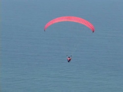AIR TO AIR, Brazil, Rio de Janeiro, Man paragliding above coastline Stock Footage