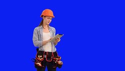 Beautiful young woman construction worker working on tablet Stock Footage