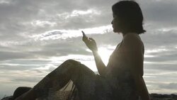 woman using smartphone on the cliff Stock Footage