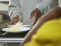 CU Dad plates scrambled eggs for daughter and son / Dallas, Texas, USA Stock Footage
