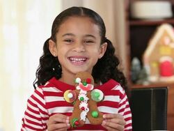 MS Portrait of Smiling Young Girl Holding Gingerbread Man Cookie / Richmond, Virginia, USA Stock Footage