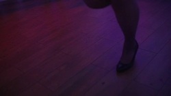 Close up of dancing women and men's feet on the dance floor at the night club or discotheque. Crowd women with beautiful legs in high heels dancing. Stock Footage