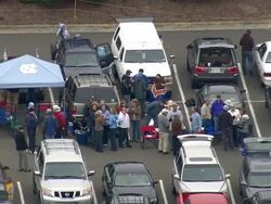 MS AERIAL Shot of Car parking area with people on Wallace Wade Stadium / North Carolina, United States Stock Footage