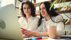 Two beautiful girls with laptop Stock Footage