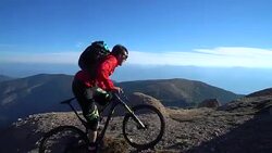Mountain bikers ascend steep mountain slope, to summit Stock Footage
