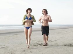 WS SLO MO  Young couple running at beach / Isle of Palms, South Carolina, USA Stock Footage