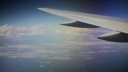 Plane Flying over Clouds Stock Footage