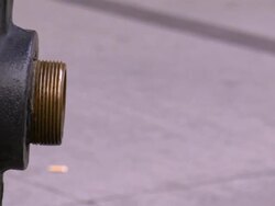 A firefighter screws a clapper valve on a fire hydrant. Stock Footage