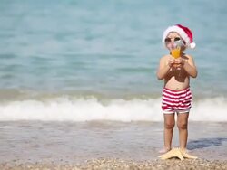 Boy Santa Claus resting on the sea Stock Footage
