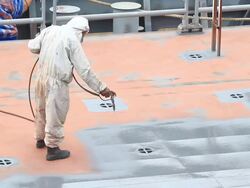 Shipyard worker paint the ship Stock Footage