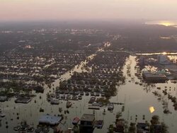 Aerial from southern shore of Lake Ponchartrain over houses submerged in water / sunset / Louisiana Stock Footage