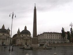 Traffic flows past an obelisk in a large courtyard. Stock Footage