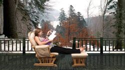 A pregnant woman relaxes in a rocking chair on a patio overlooking a snowy woodland. Stock Footage