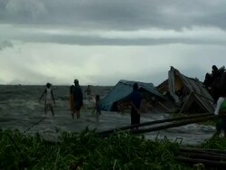 People dragging materials from water as shanty houses are flooded; aftermath of typhoon Mirinae, Philippines, 2009 Stock Footage