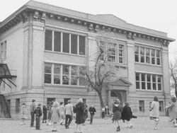 Children playing outside grade school Stock Footage