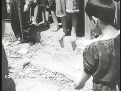 1945: OKINAWA, JAPAN: CIVILIAN INTERNMENT CAMP: WS People behind barbed wire. Soldier numbering child's arm w/ paint. Numbering baby on mother's back w/ 334. Pacific Theater, WWII, World War II. Instructional Video