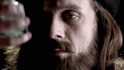 Nostradamus examines the liquid in a vial. Stock Footage